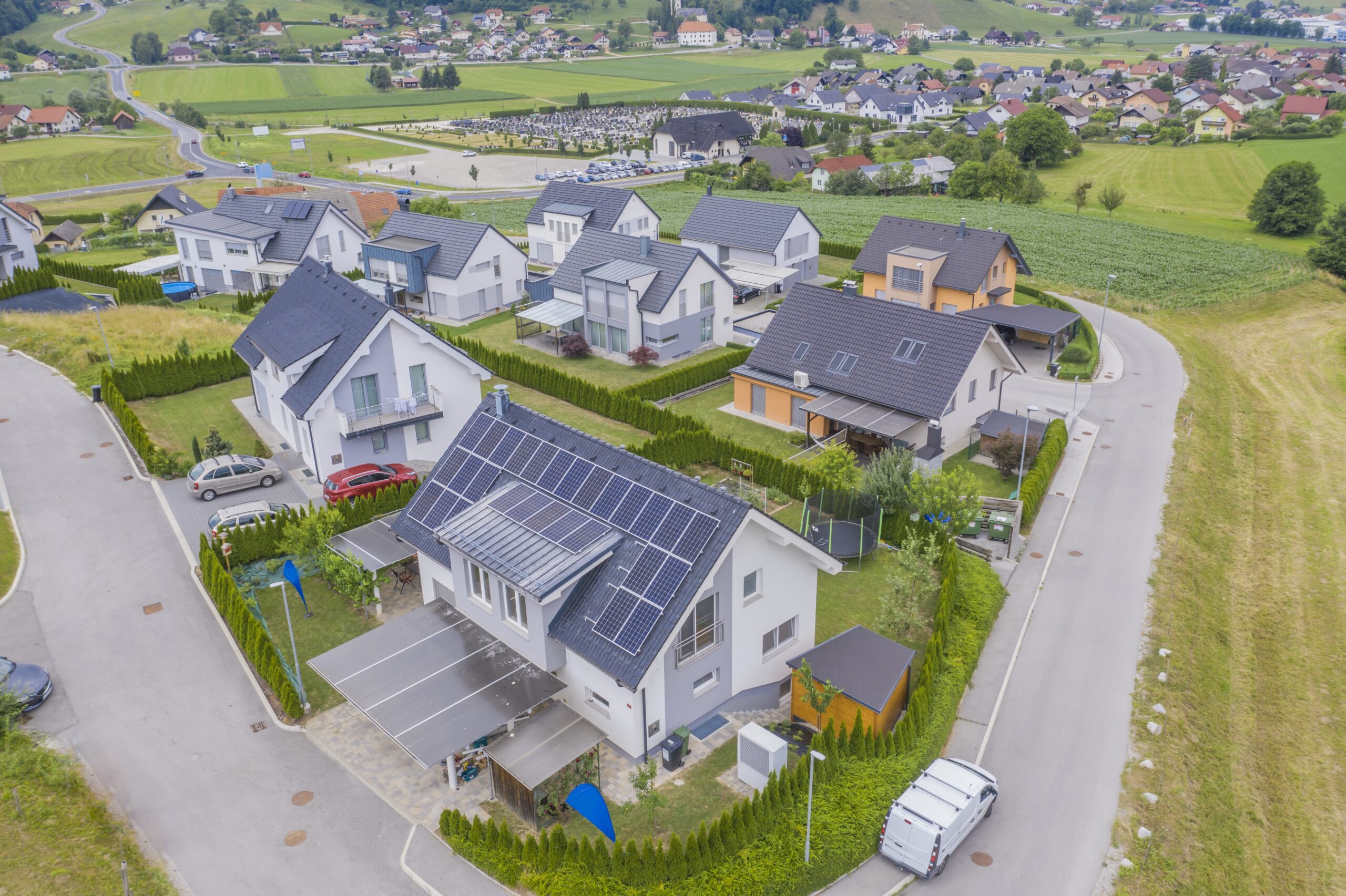 A high angle shot of private houses with solar panels on the roofs